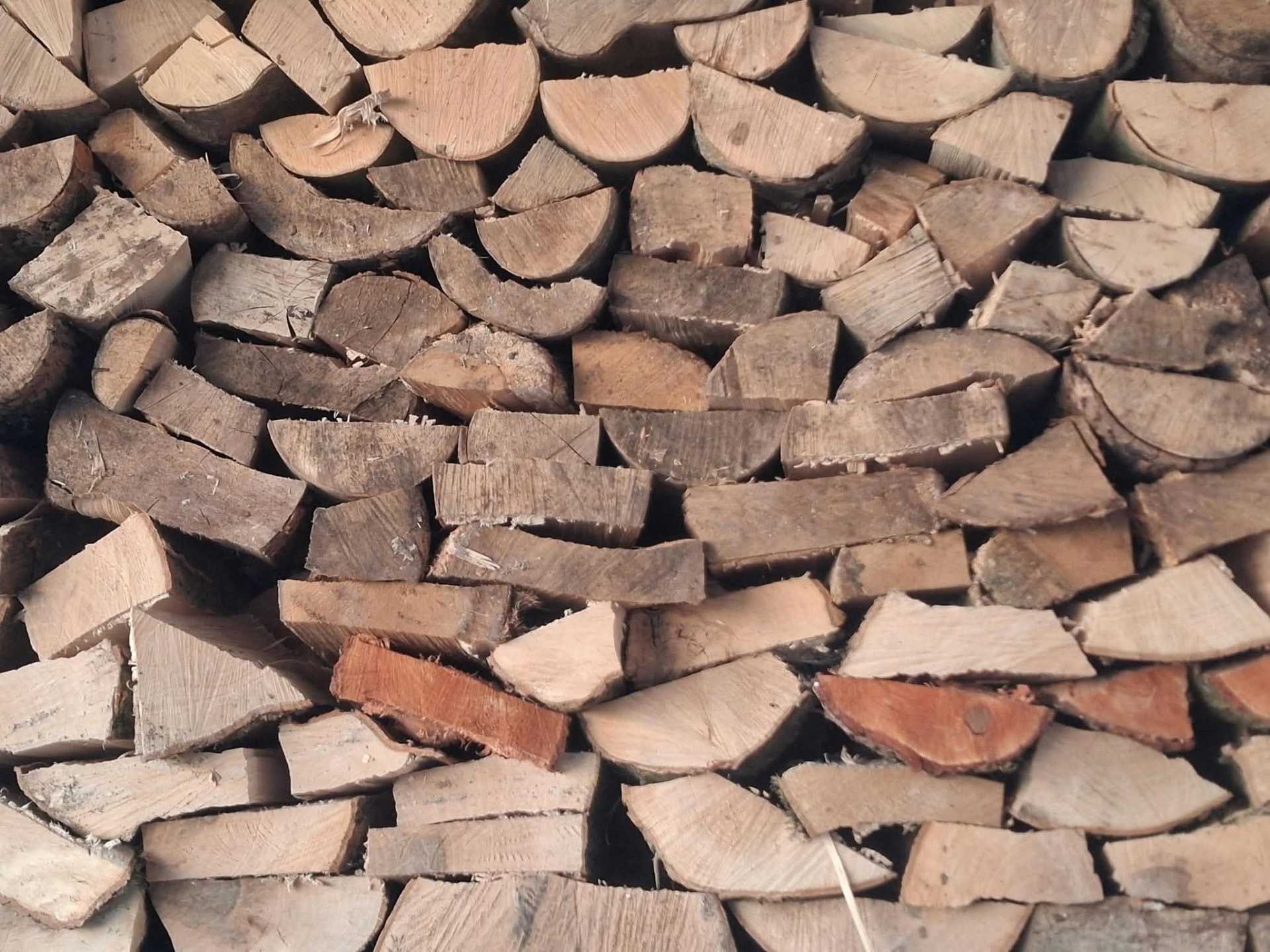 A neatly stacked pile of split seasoned Dorset firewood